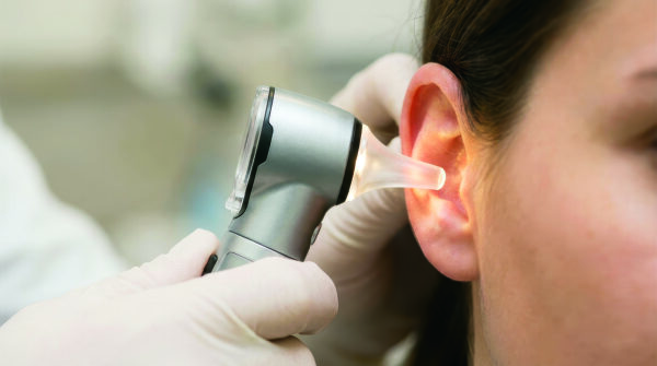 Provider examining patient ear